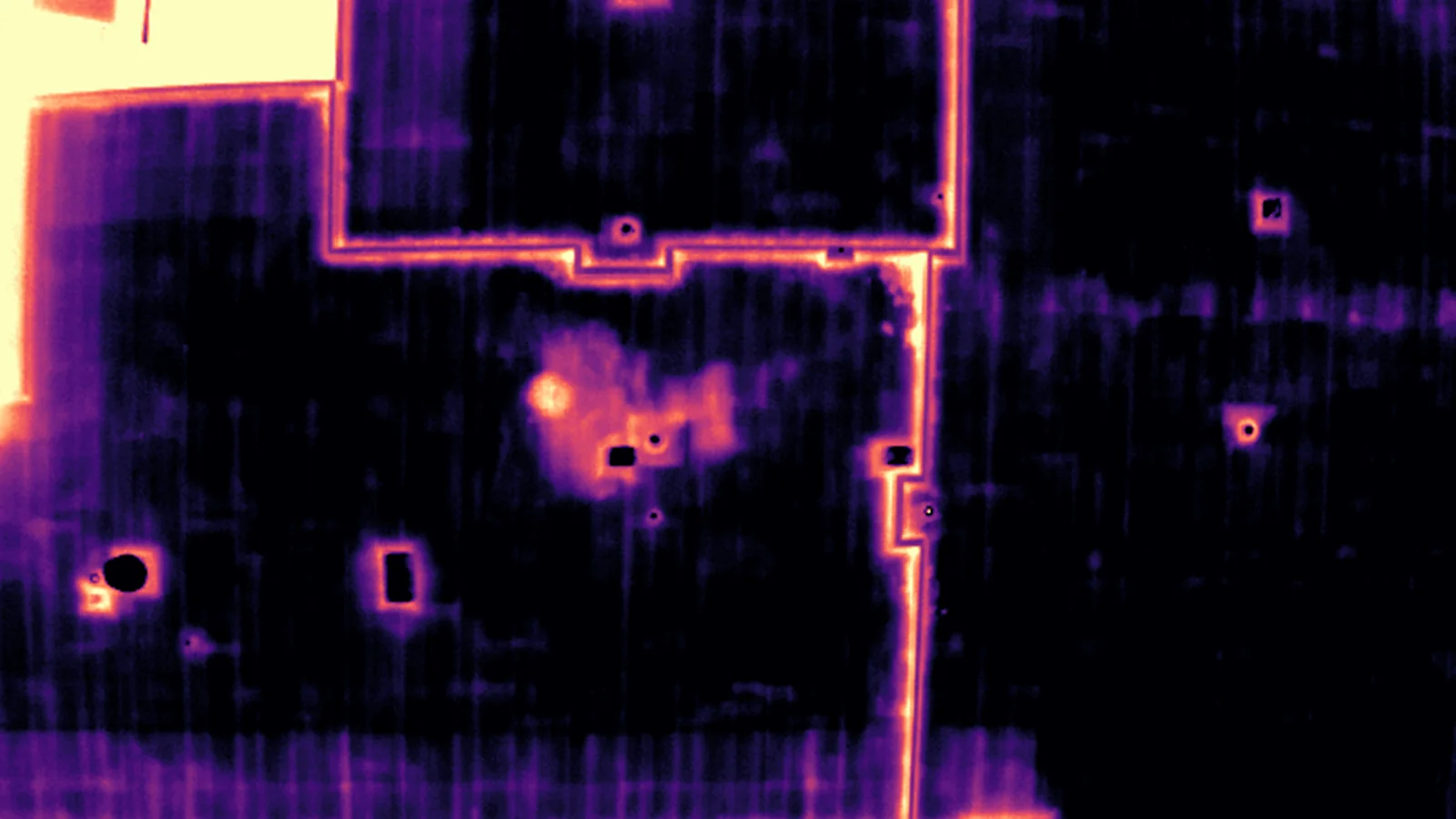 Matched radiometric thermal close-up of the same roof area, magma palette.